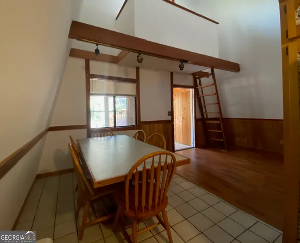 a view of dining room with furniture and wooden floor