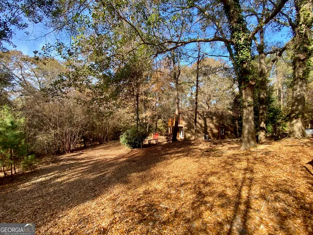 a backyard of a house with large trees
