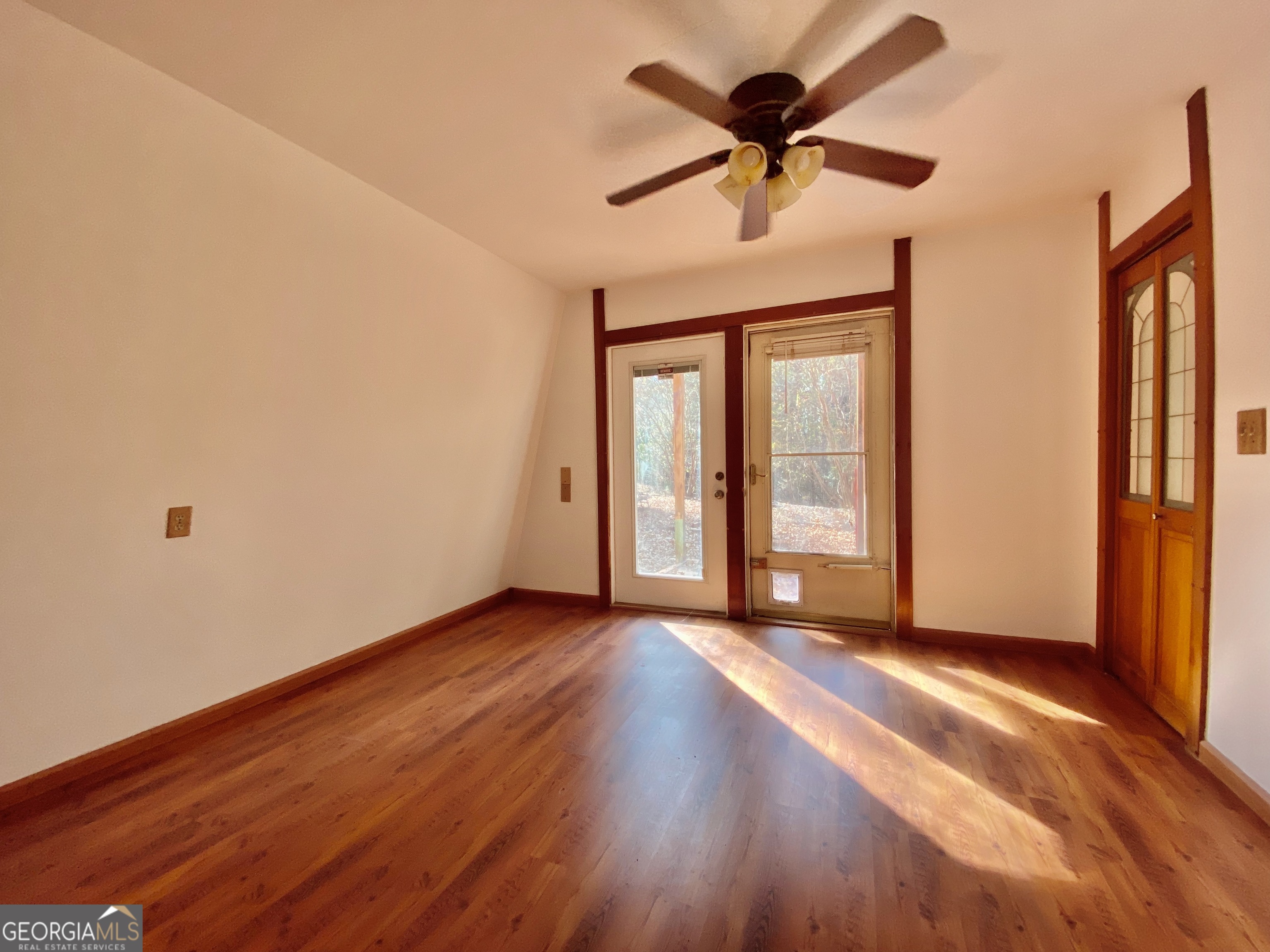 231 West Seminole Drive Byron, GA 31008 - Photo 8 of 38 a view of an empty room with a window and wooden floor