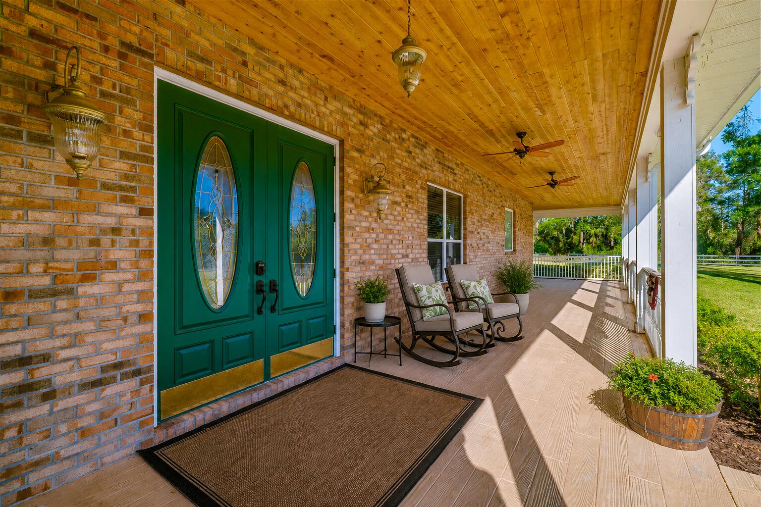 8686 Andrews Avenue Fort Pierce, FL 34945 - Photo 12 of 76 a view of a two chair in the patio with potted plants