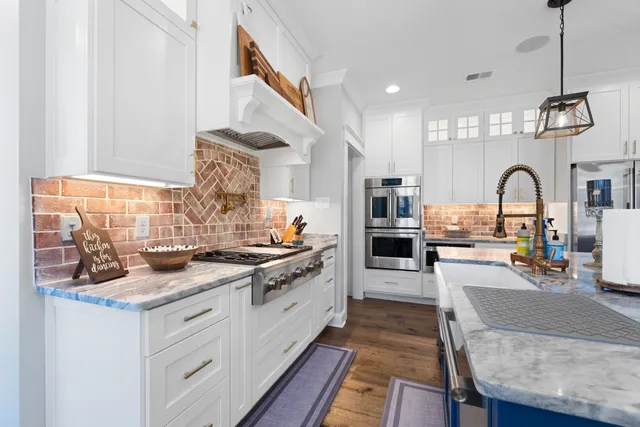 a kitchen with stainless steel appliances granite countertop a stove and refrigerator