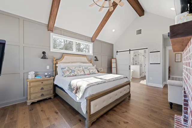 a bedroom with a bed and a night stand