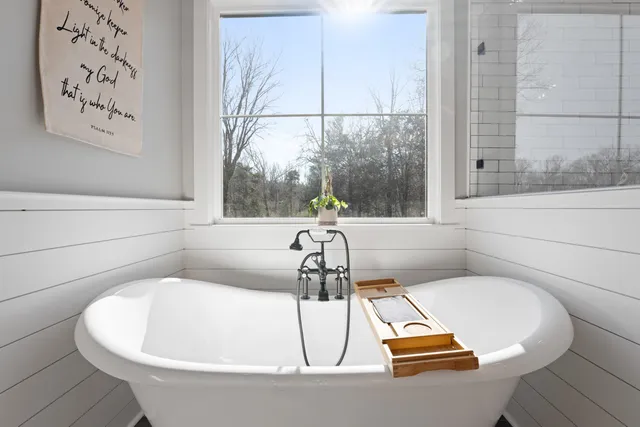 a bath tub sitting next to a window