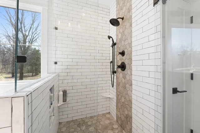 a bathroom with a sink a mirror and shower