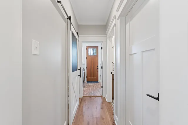 a view of a hallway with wooden floor