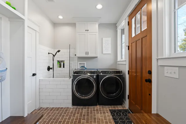 a bathroom with a washing machine and utility