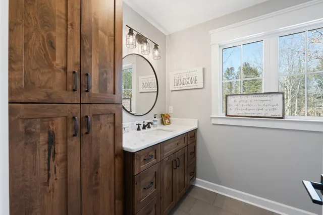 a bathroom with a sink a vanity and a mirror