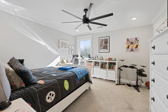 a bedroom with a bed and a chandelier