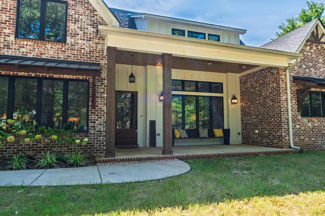 front view of a brick house with a yard