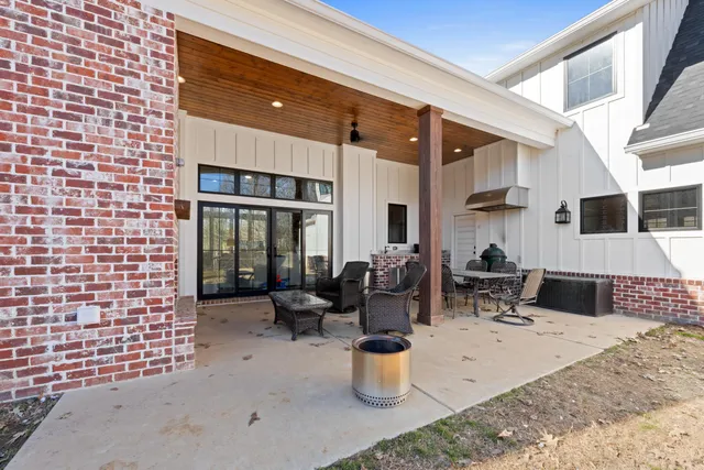 a view of a patio with dining table and chairs and potted plants