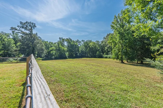 a view of a swimming pool with a yard