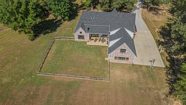 an aerial view of a house with a yard and balcony