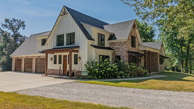 a front view of house with yard and trees around