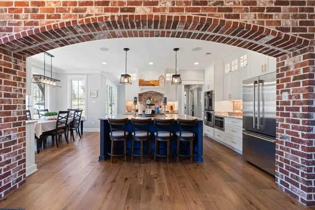 a view of a dining room with furniture and wooden floor