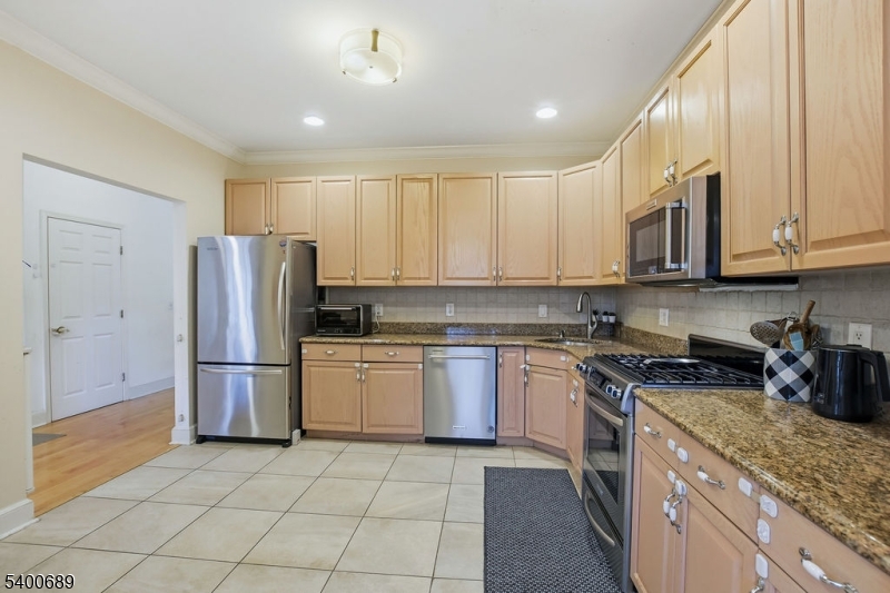 29 Pine Valley Road Livingston, NJ 07039 - Photo 11 of 30 a kitchen with a sink a refrigerator and cabinets