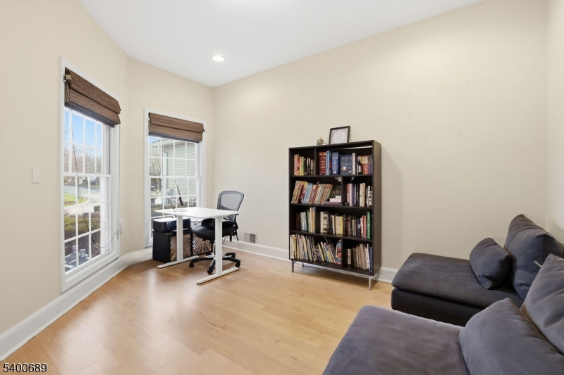 29 Pine Valley Road Livingston, NJ 07039 - Photo 12 of 30 a livingroom with a couch and a bookshelf