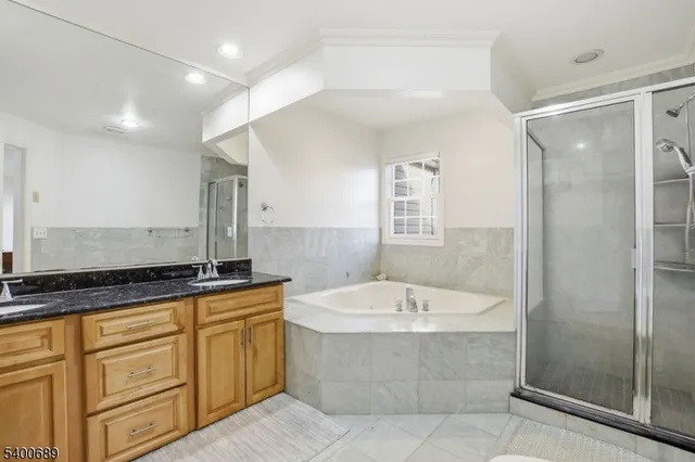 a bathroom with a granite countertop bathtub sink and mirror