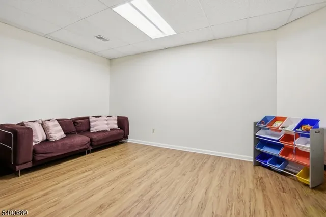 a living room with a couch and a wooden floor