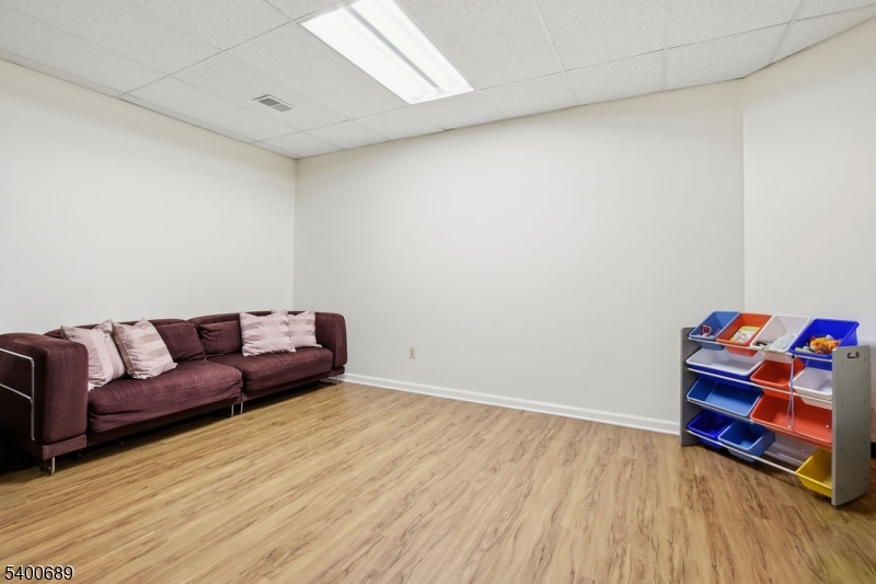 29 Pine Valley Road Livingston, NJ 07039 - Photo 23 of 30 a living room with a couch and a wooden floor