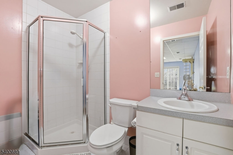 29 Pine Valley Road Livingston, NJ 07039 - Photo 24 of 30 a bathroom with a sink a mirror a toilet and shower