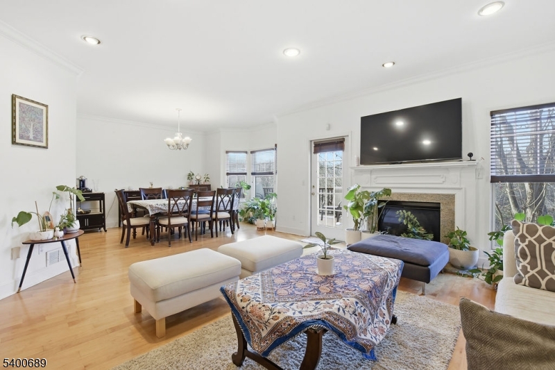 29 Pine Valley Road Livingston, NJ 07039 - Photo 5 of 30 a living room with furniture a fireplace and a flat screen tv