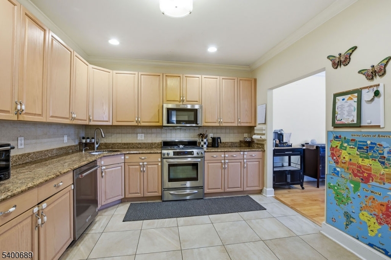 29 Pine Valley Road Livingston, NJ 07039 - Photo 10 of 30 a kitchen with stainless steel appliances granite countertop a sink and dishwasher a stove top oven with wooden floor