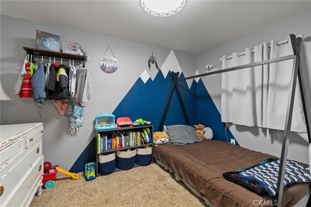 5150 Miners Ranch Road Oroville, CA 95966 - Photo 15 of 36 a bedroom with bed and a baby