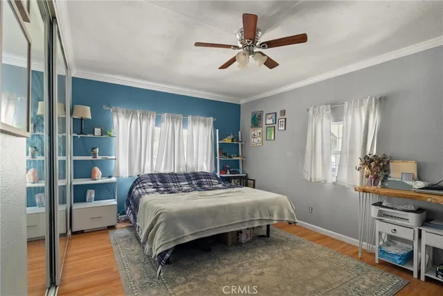 a bedroom with a bed a window and a chandelier