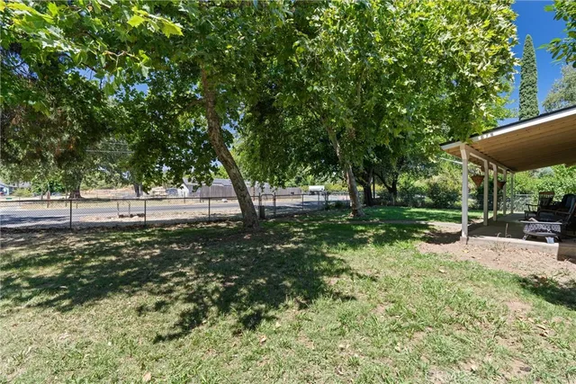 a view of a house with yard and a tree