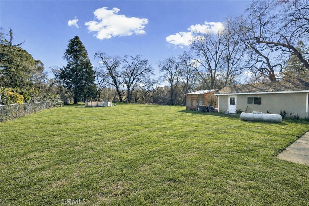 5150 Miners Ranch Road Oroville, CA 95966 - Photo 2 of 12 a view of a house with backyard and trees