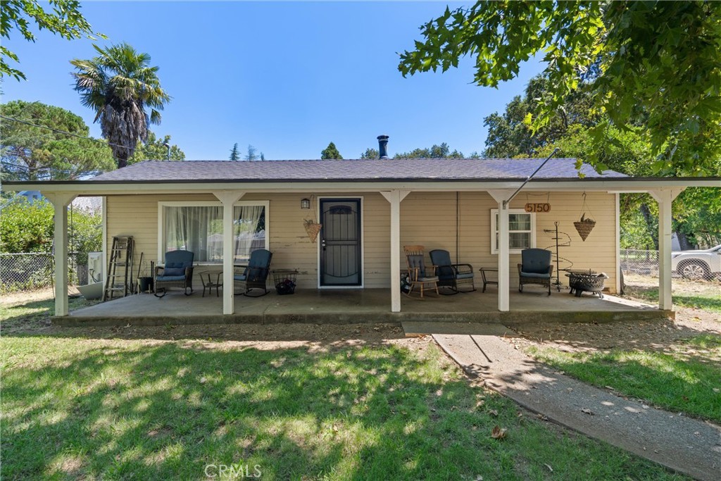 5150 Miners Ranch Road Oroville, CA 95966 - Photo 2 of 36 a view of a yard in front of a house with large windows