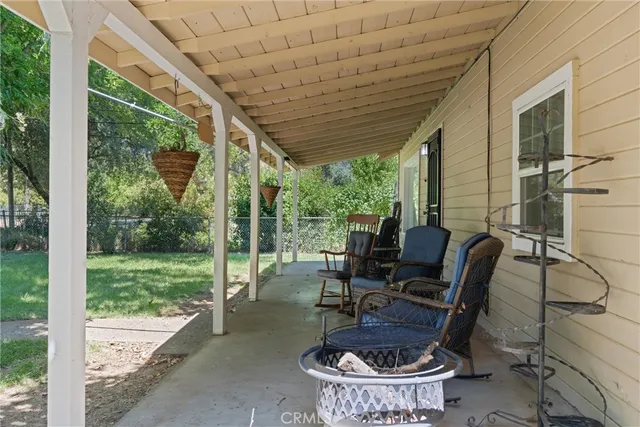 a backyard of a house with table and chairs