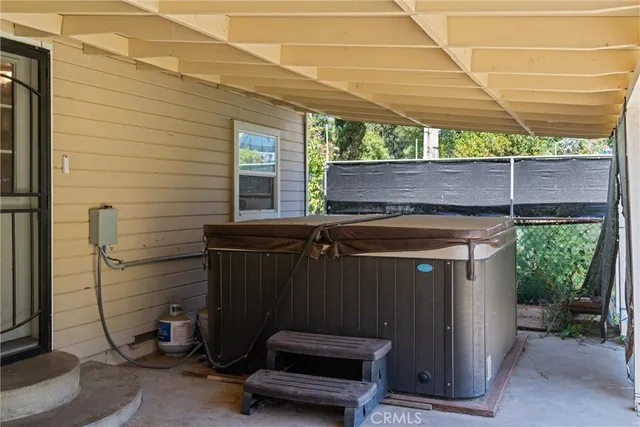 a view of a patio with table and chairs with wooden floor and fence