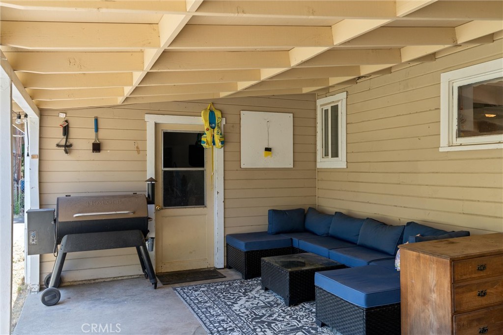 5150 Miners Ranch Road Oroville, CA 95966 - Photo 26 of 36 a view of a patio with table and chairs with wooden floor and fence