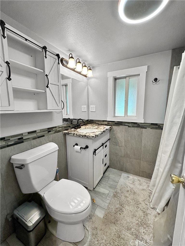 5150 Miners Ranch Road Oroville, CA 95966 - Photo 7 of 12 a bathroom with a sink a toilet and a mirror