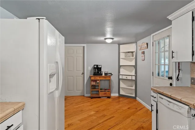a room with a bed and a view of kitchen