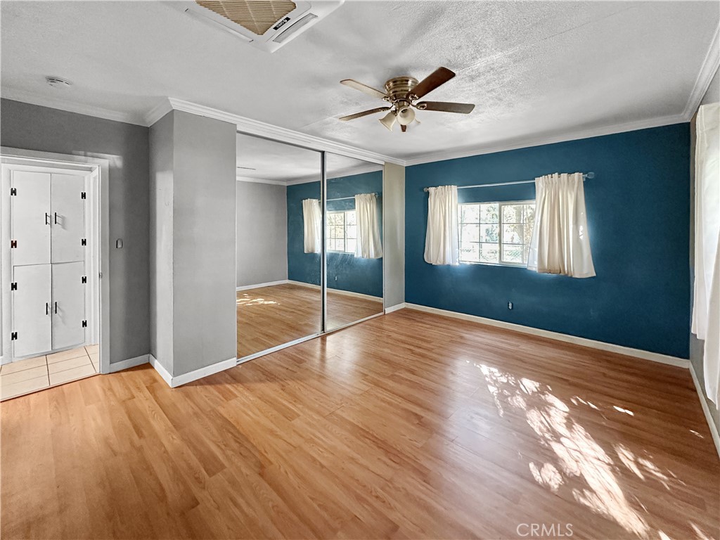 5150 Miners Ranch Road Oroville, CA 95966 - Photo 10 of 12 a view of empty room with wooden floor and fan