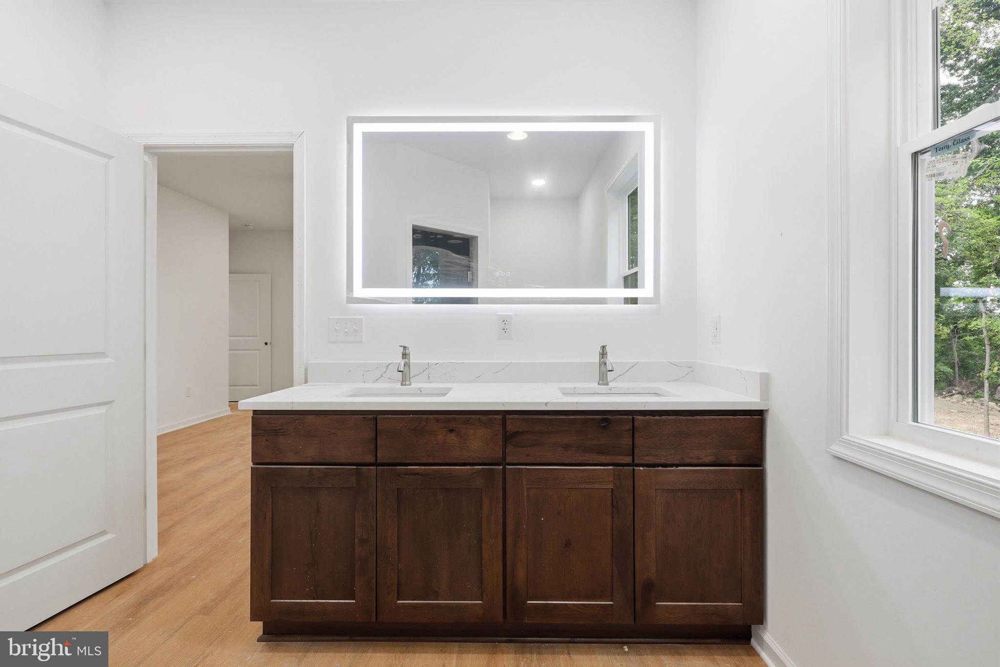 10339 Back Creek Valley Road Hedgesville, WV 25427 - Photo 24 of 48 a bathroom with a sink vanity and mirror