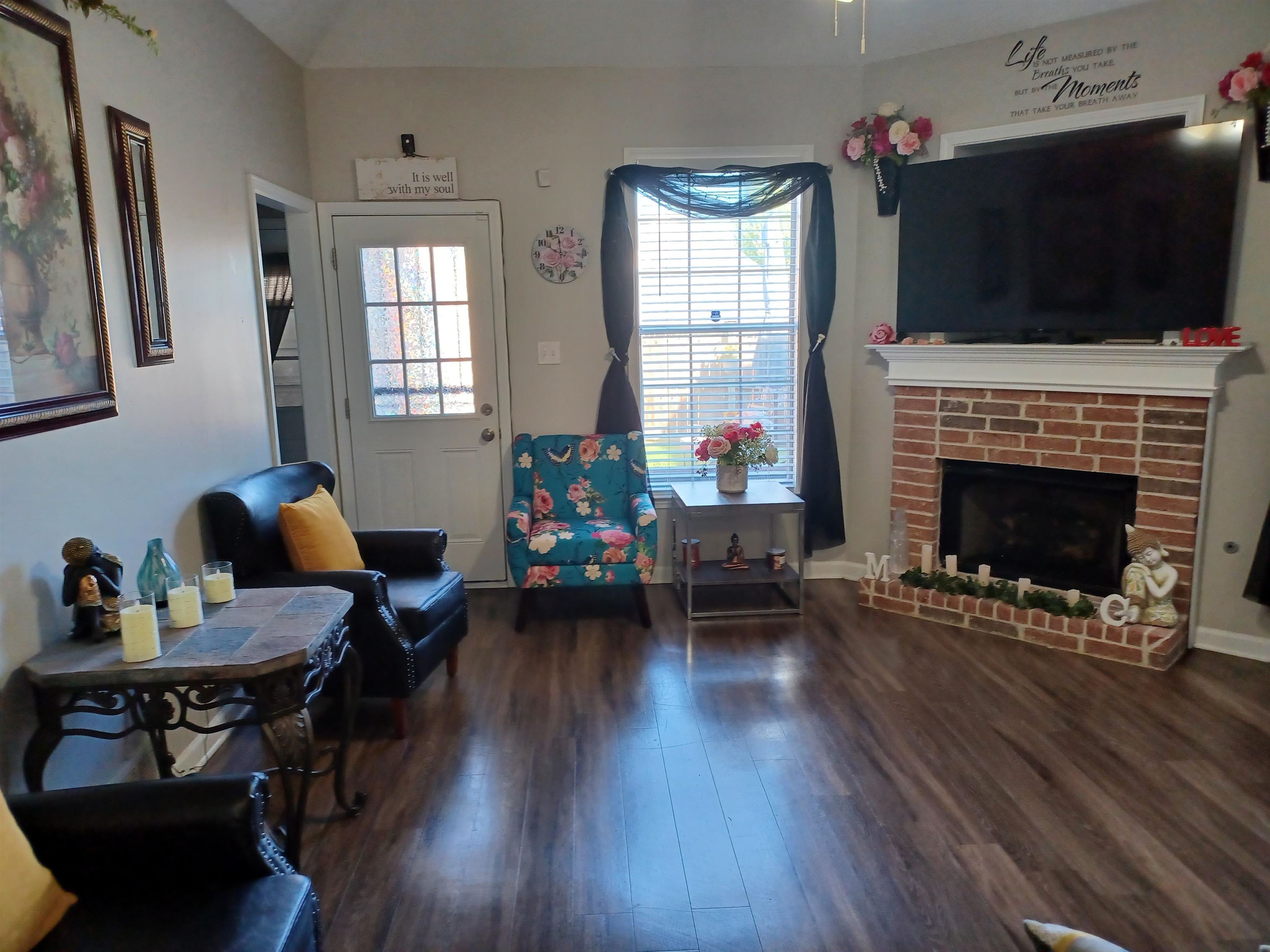 8700 Macon Road Memphis, TN 38018 - Photo 2 of 18 a living room with furniture a flat screen tv and a fireplace