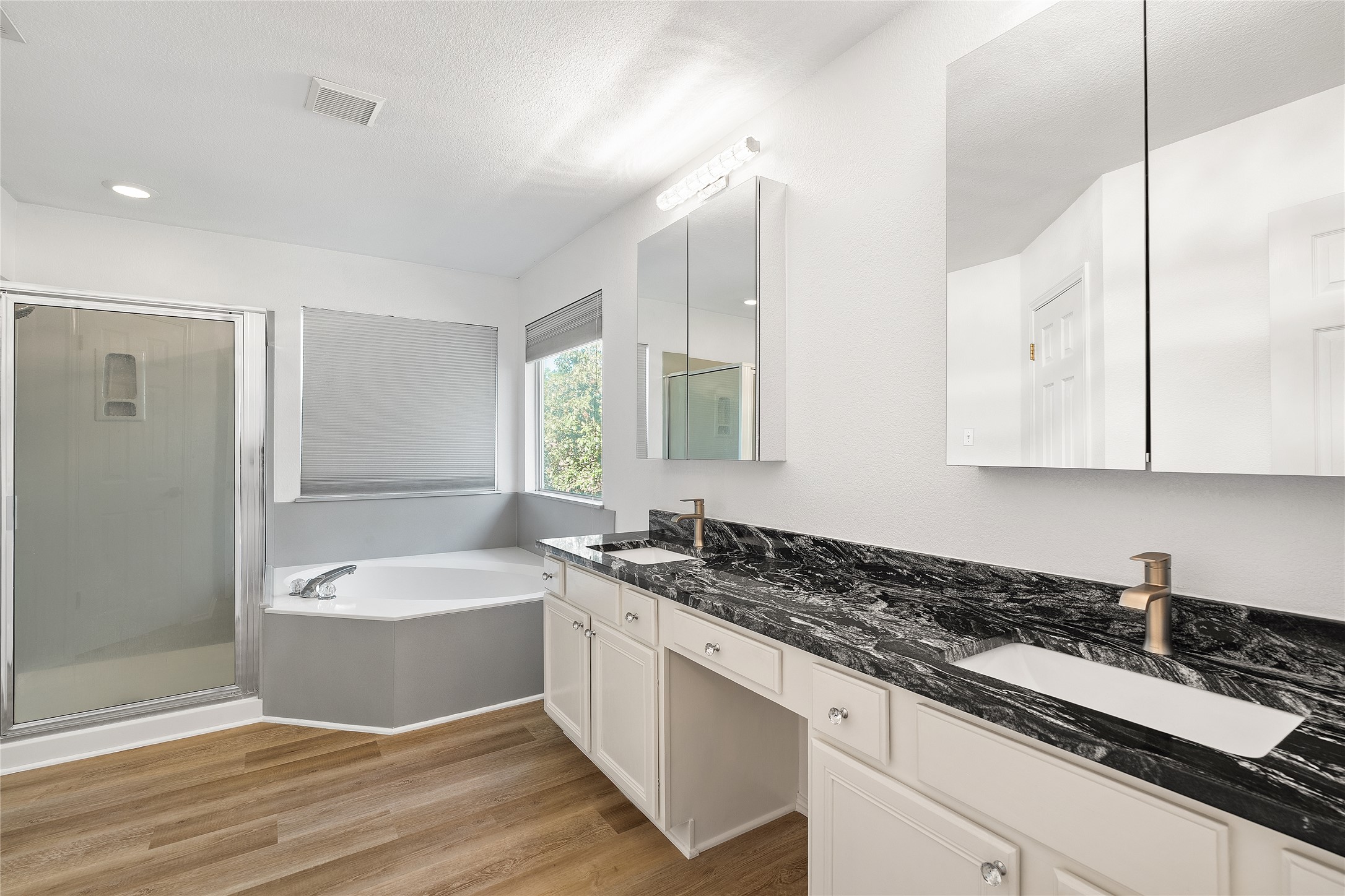 206 River Down Road Georgetown, TX 78628 - Photo 31 of 39 Dual vanity with a dark patterned countertop, integrated rectangular sinks, and brass-finish faucets