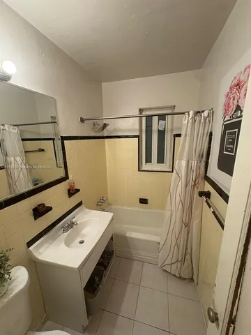 a bathroom with a sink toilet and tub
