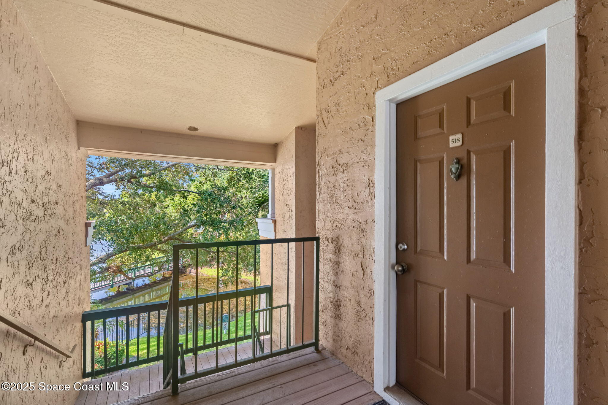 a view of a balcony with wooden floor