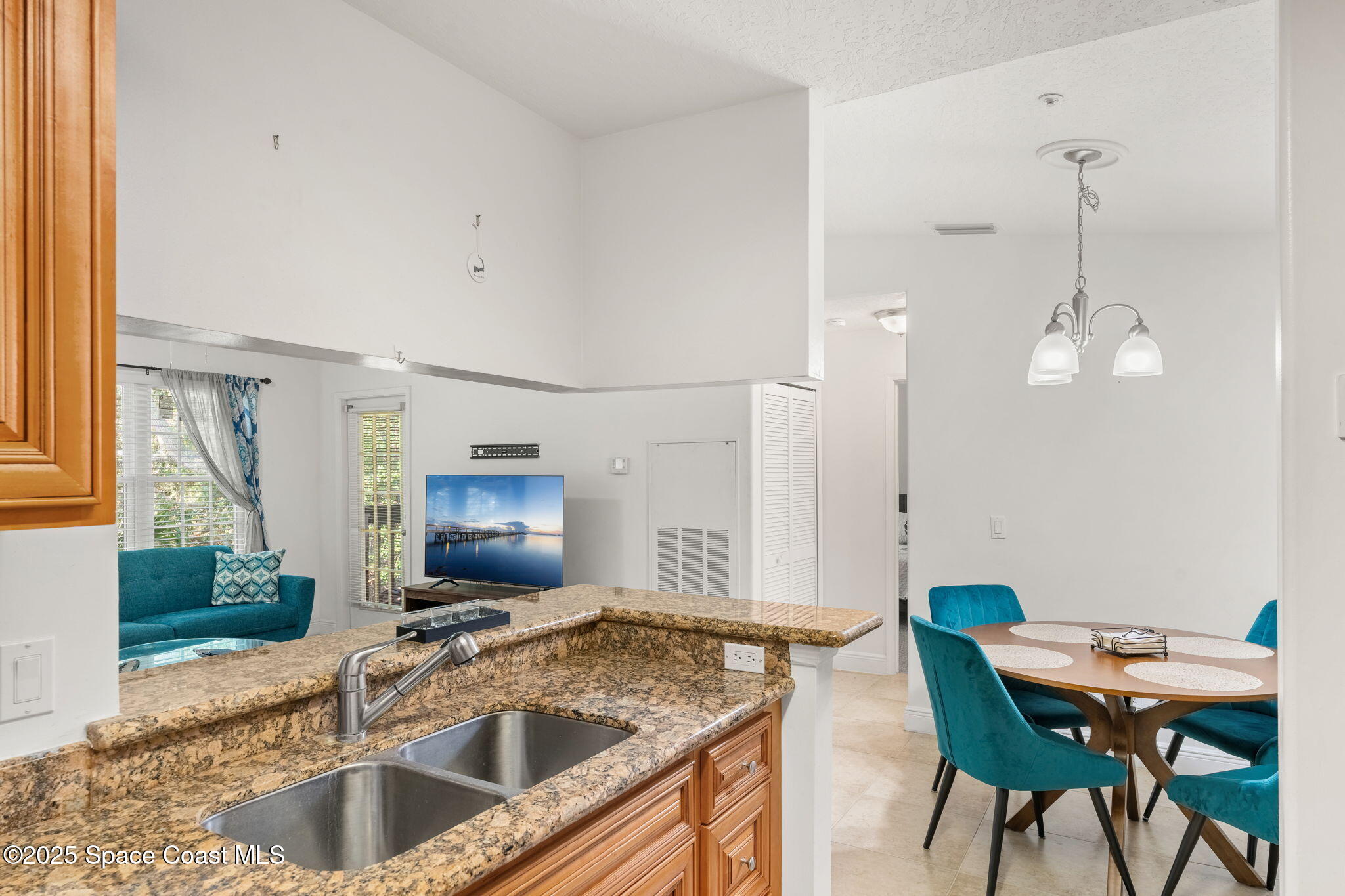 7667 North Wickham Road, Unit 518 Melbourne, FL 32940 - Photo 10 of 34 a kitchen with a table chairs and microwave