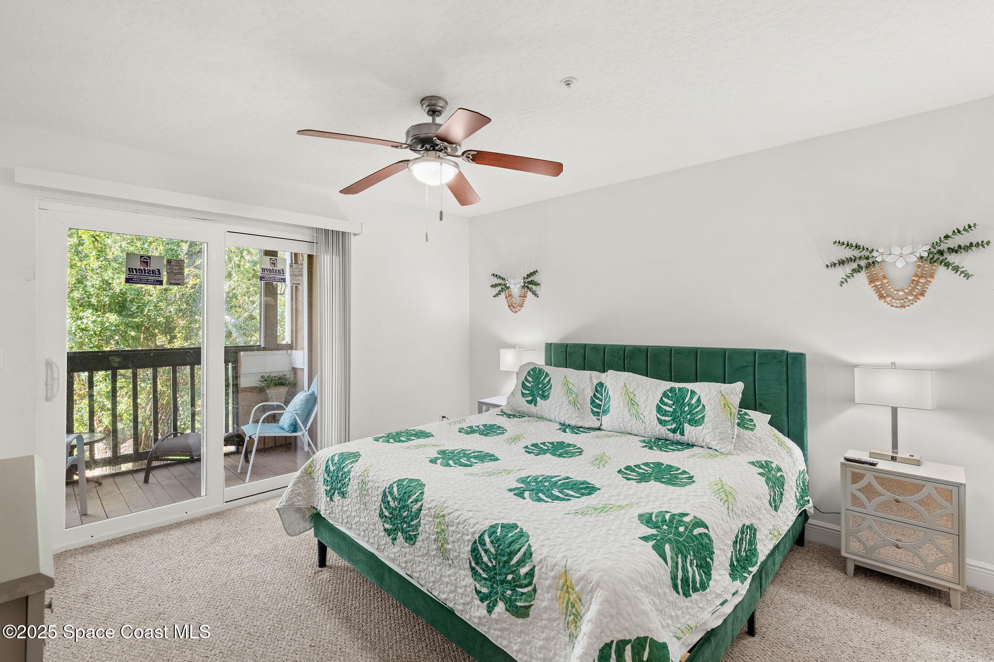7667 North Wickham Road, Unit 518 Melbourne, FL 32940 - Photo 11 of 34 a bedroom with a bed and a chandelier