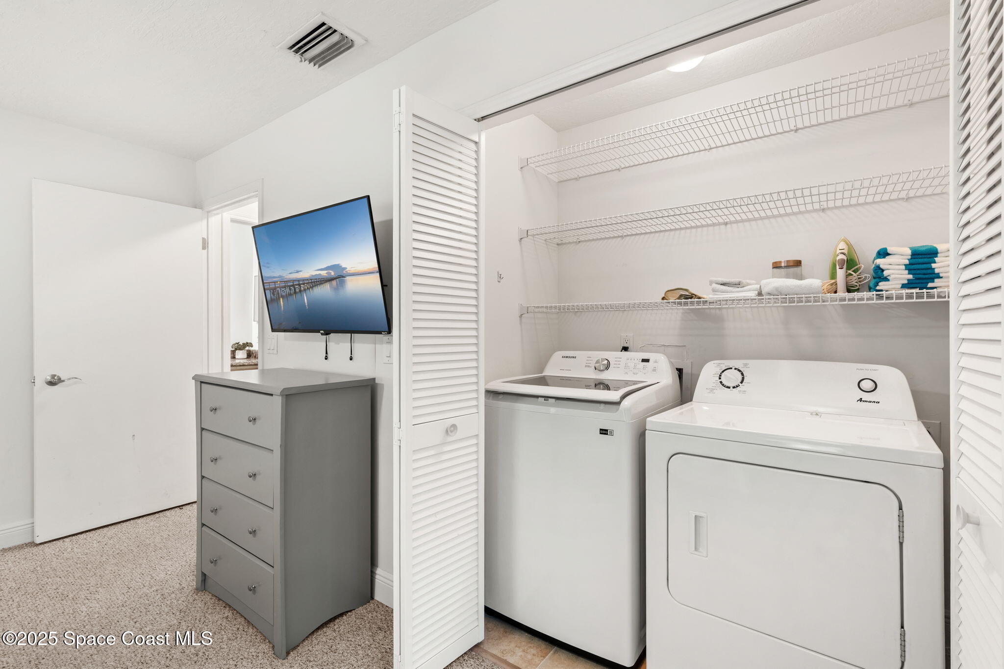 7667 North Wickham Road, Unit 518 Melbourne, FL 32940 - Photo 13 of 34 a view of storage and utility room with washer and dryer
