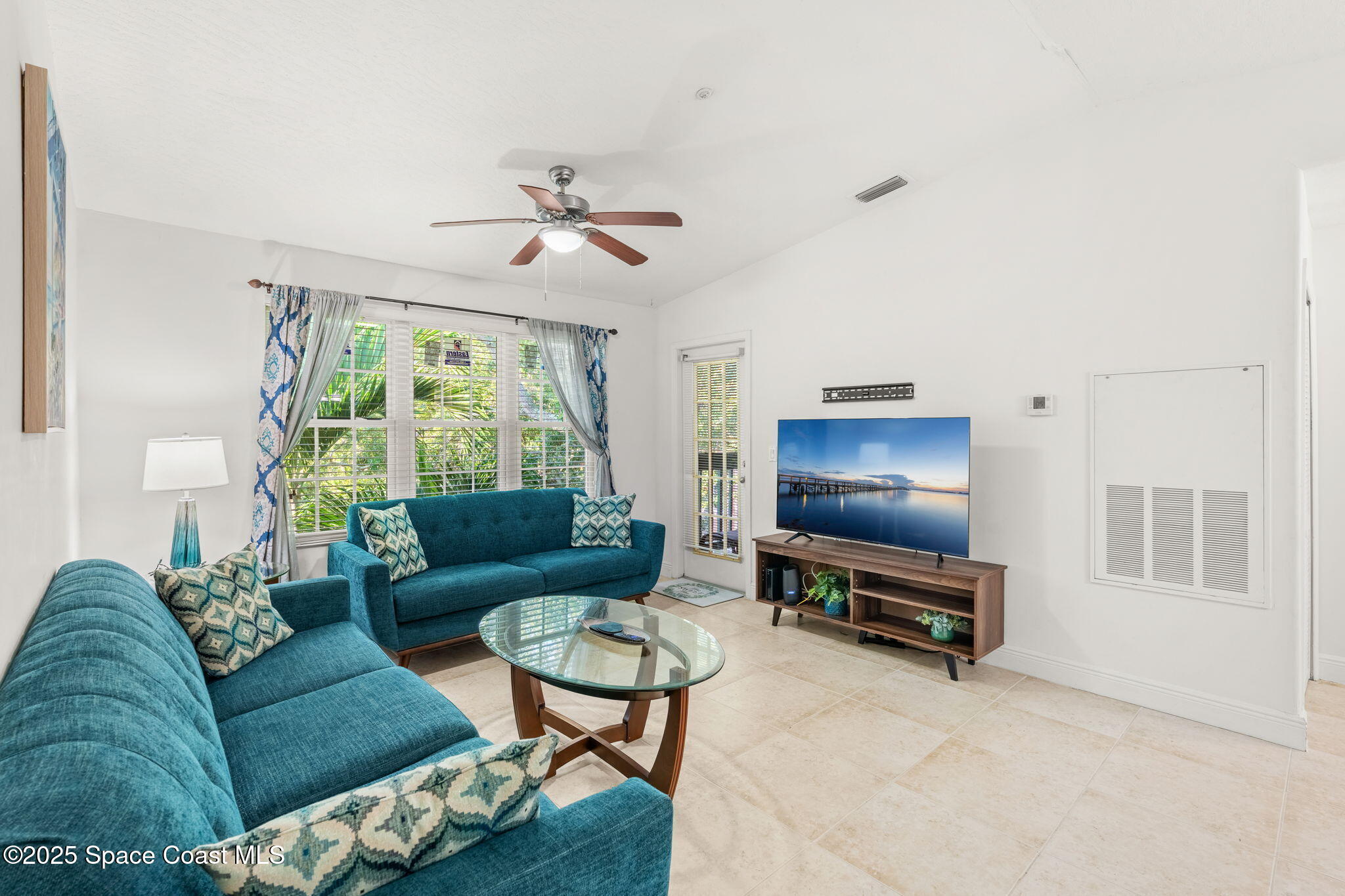 7667 North Wickham Road, Unit 518 Melbourne, FL 32940 - Photo 18 of 34 a living room with furniture a window and a flat screen tv