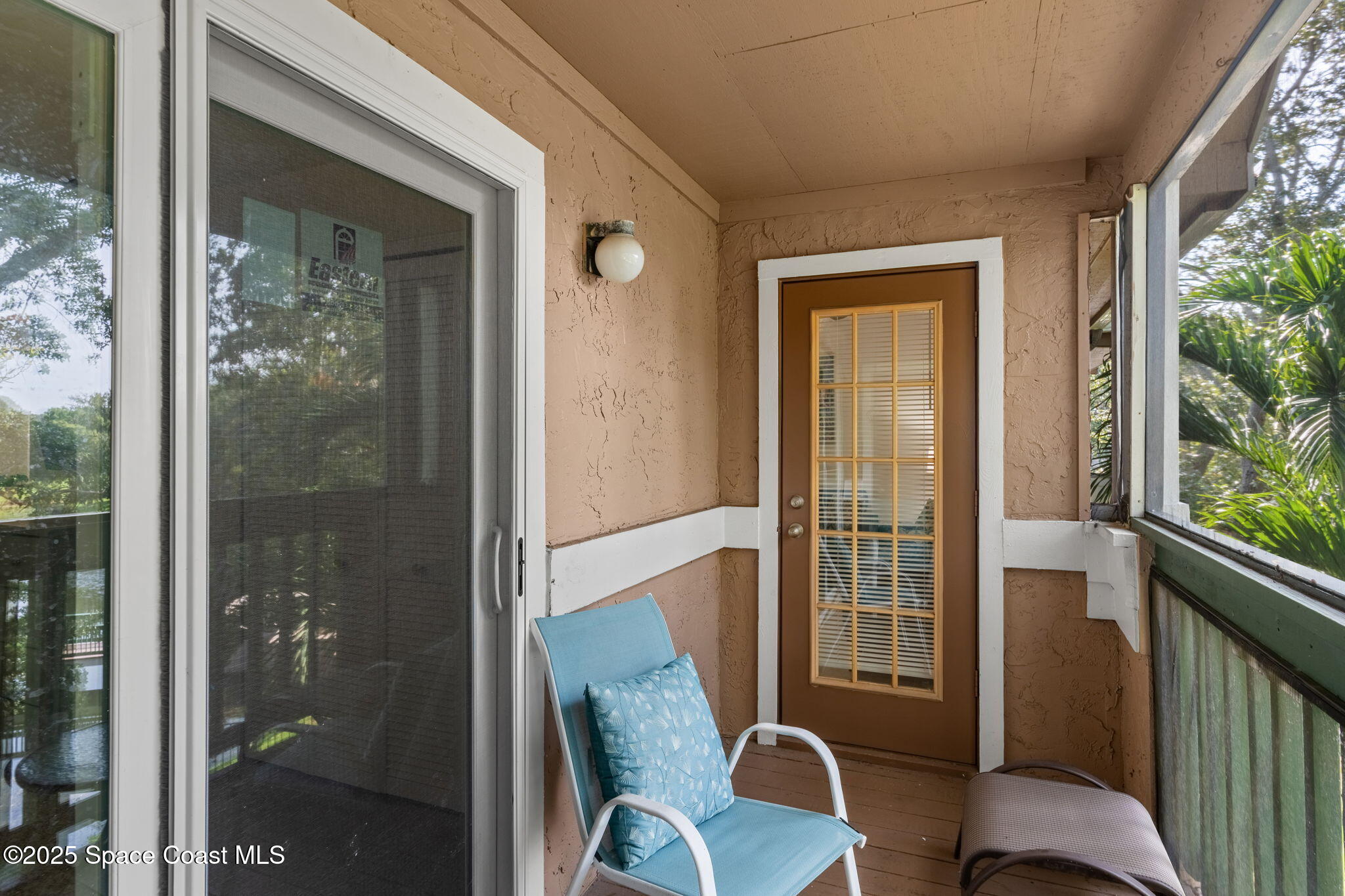 7667 North Wickham Road, Unit 518 Melbourne, FL 32940 - Photo 20 of 34 a view of a balcony with chair and table