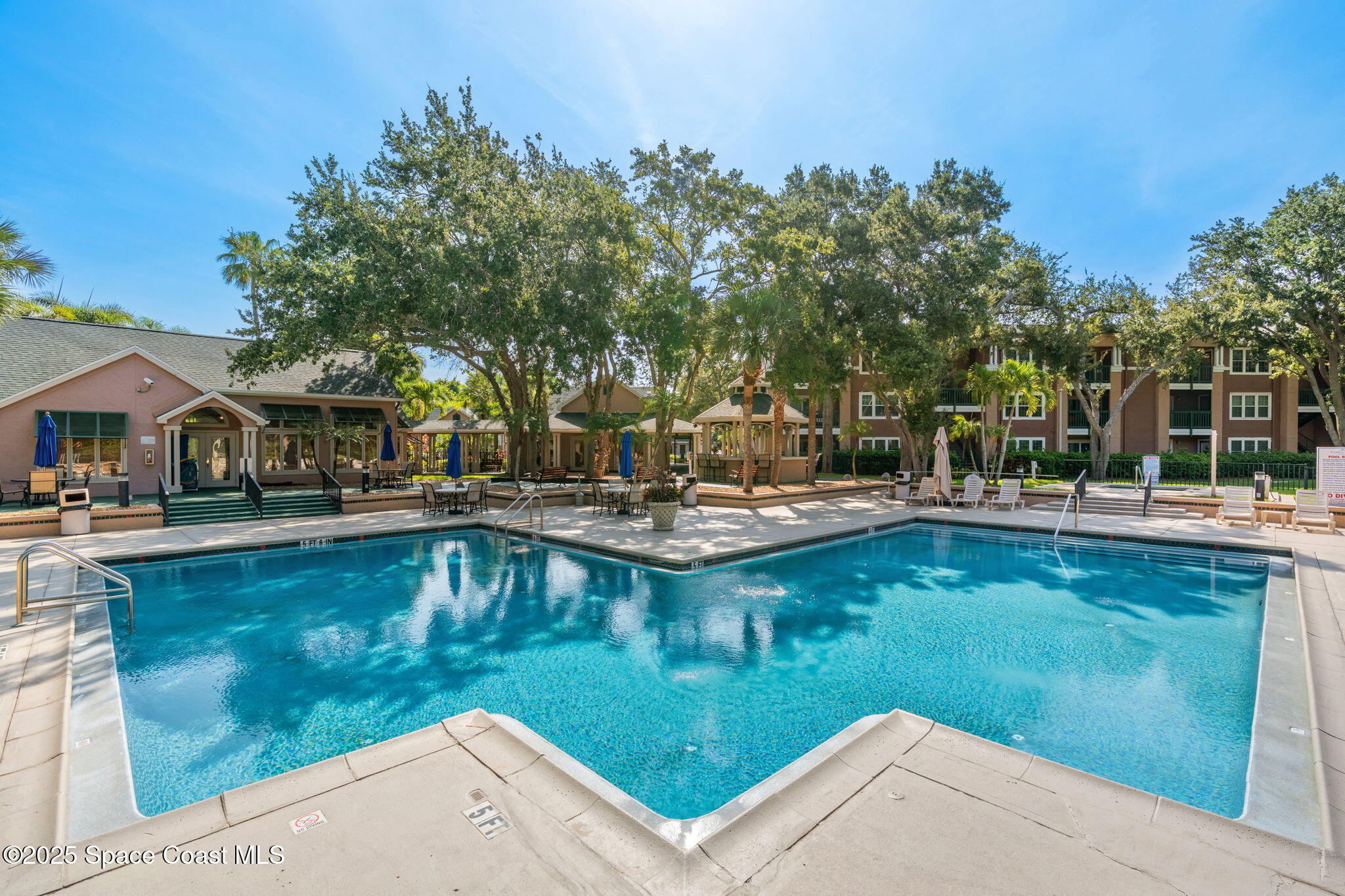 7667 North Wickham Road, Unit 518 Melbourne, FL 32940 - Photo 21 of 34 a view of a swimming pool with chairs