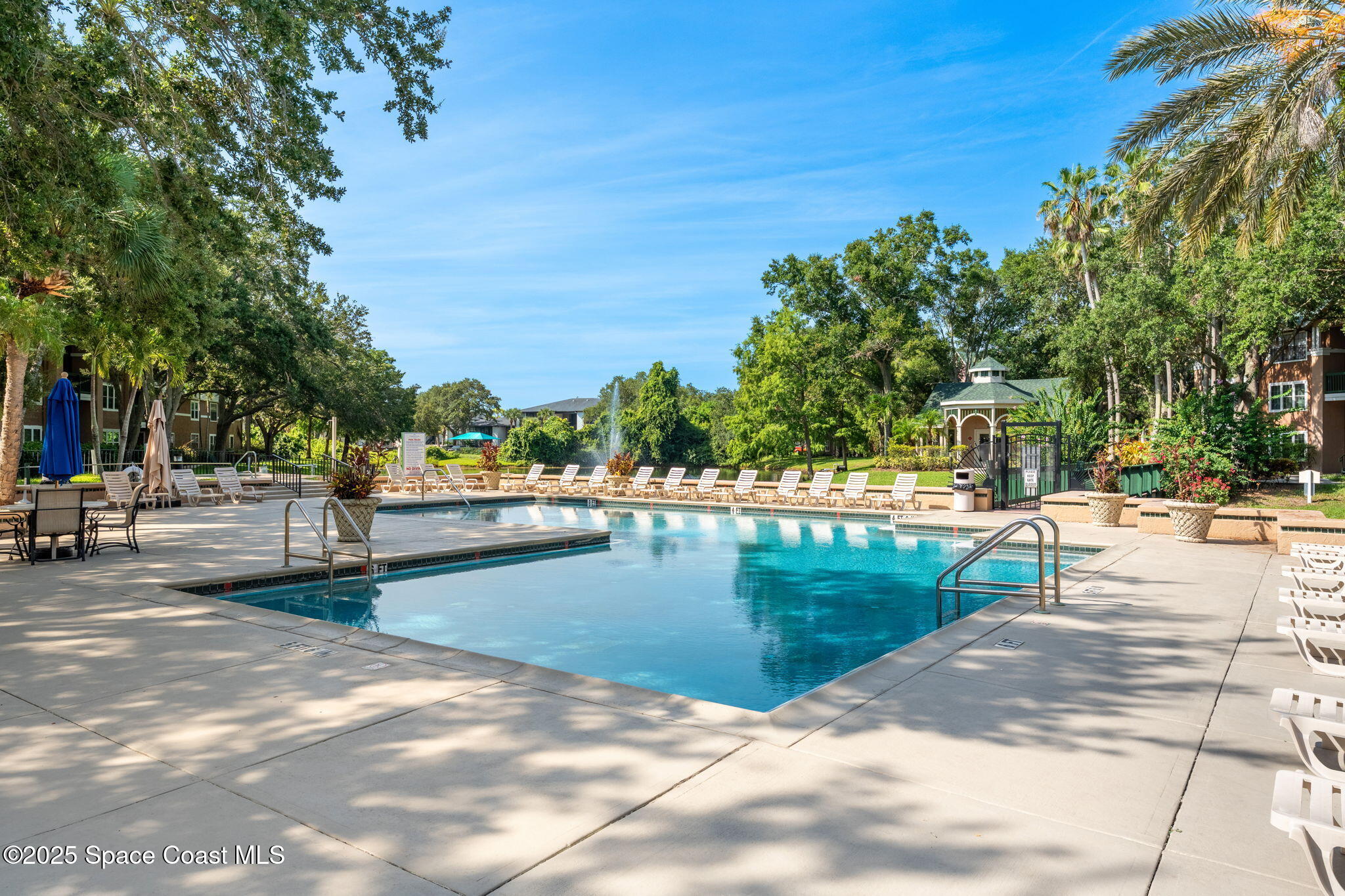 7667 North Wickham Road, Unit 518 Melbourne, FL 32940 - Photo 22 of 34 a view of a swimming pool with an outdoor seating