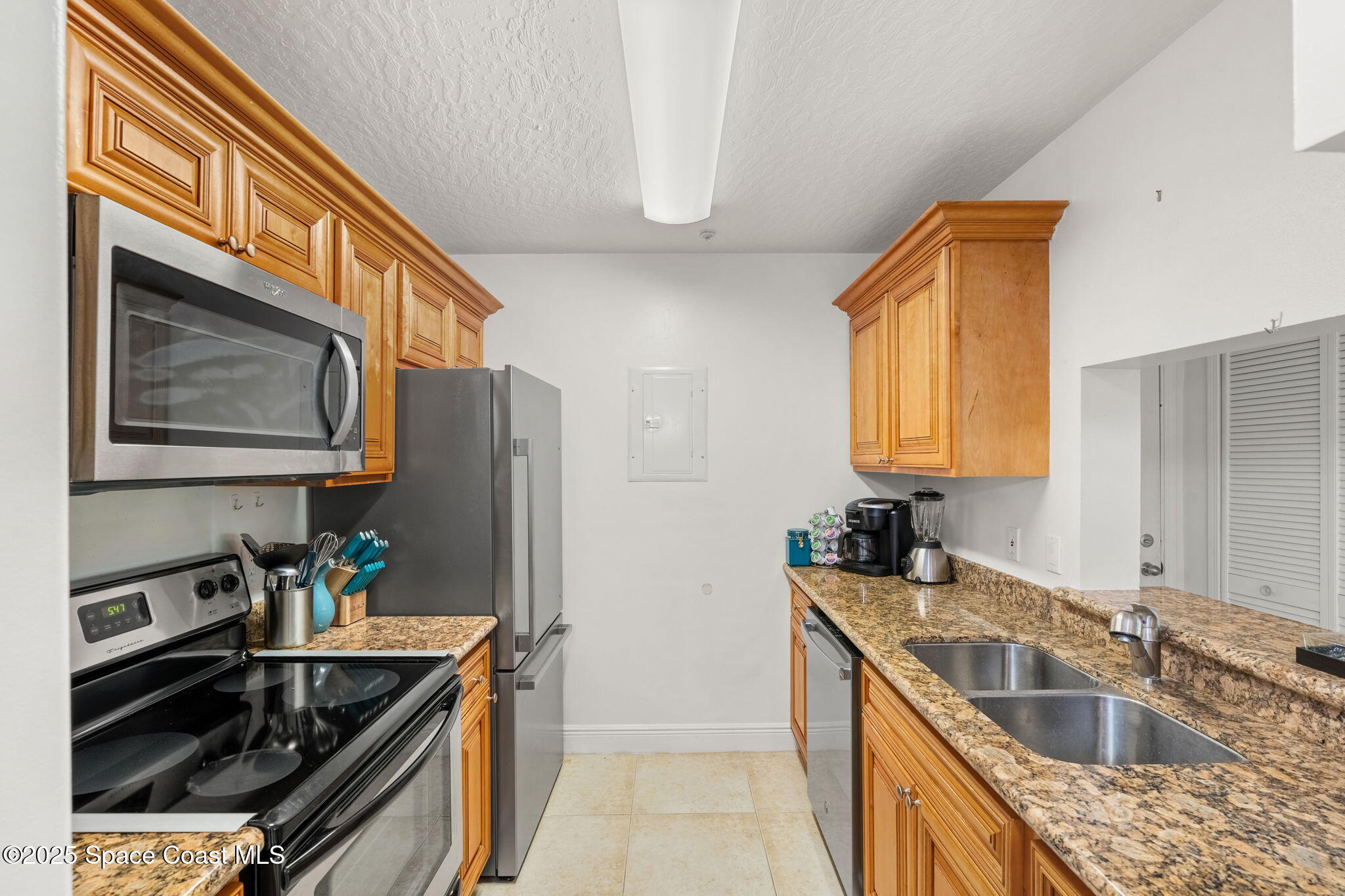 7667 North Wickham Road, Unit 518 Melbourne, FL 32940 - Photo 8 of 34 a kitchen that has a sink and a stove